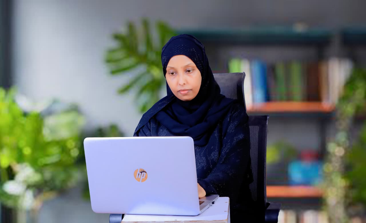 Ludfia Maalim working at her desk