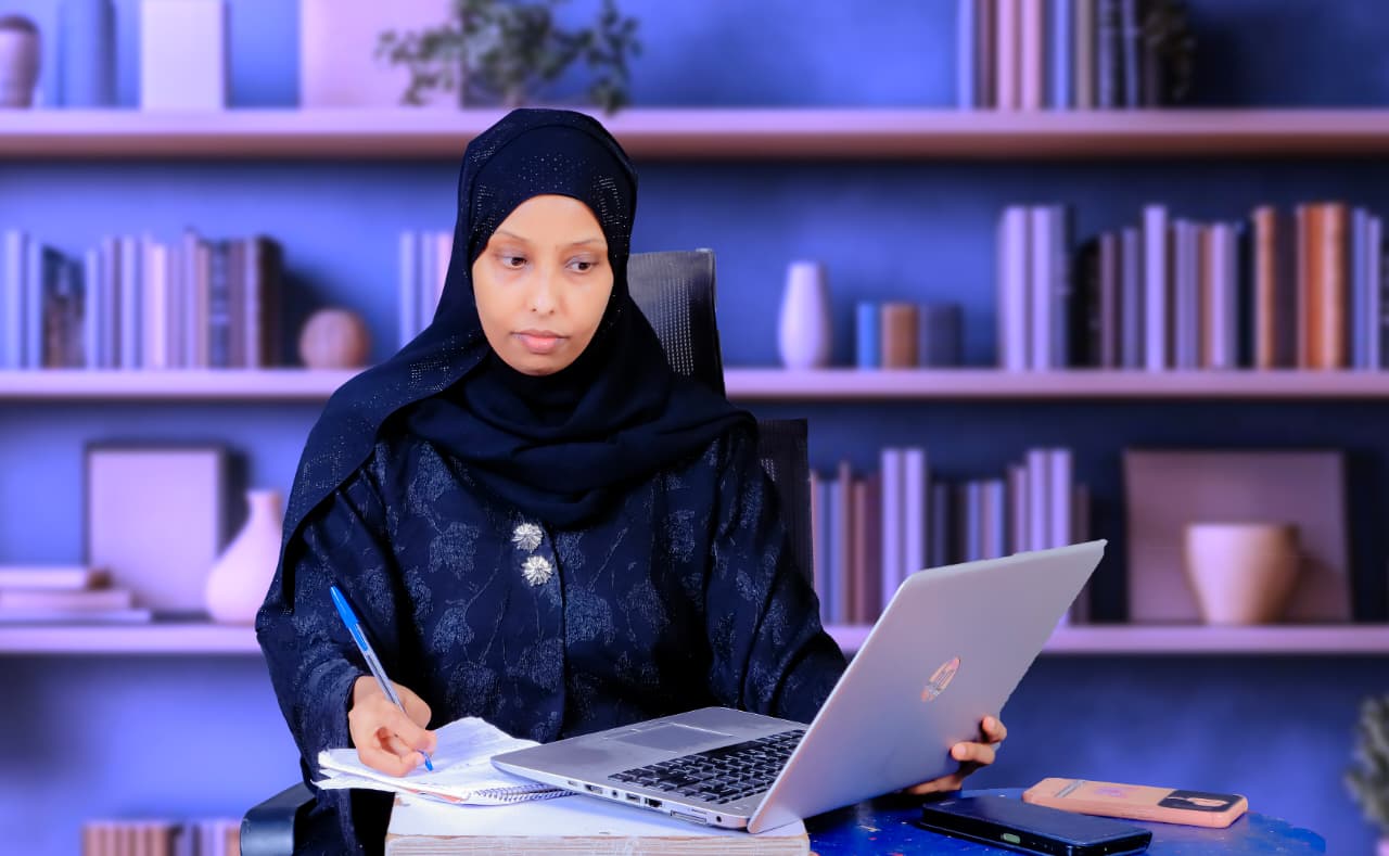 Ludfia Maalim reviewing notes at her laptop